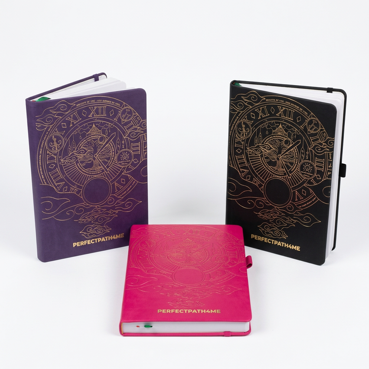 Black, pink, and purple PerfectPath4Me manifestation planners together on a white background